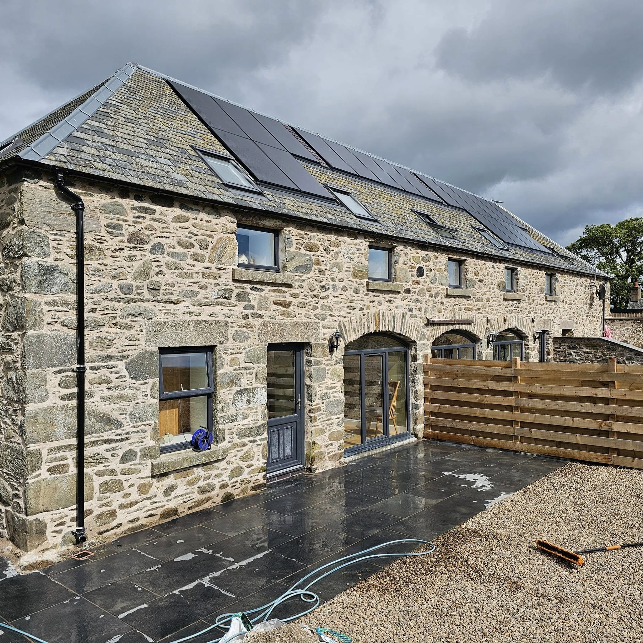 Steading conversion in Perthshire — stone elevation with arched doorways, restored by Stone Smart Scotland